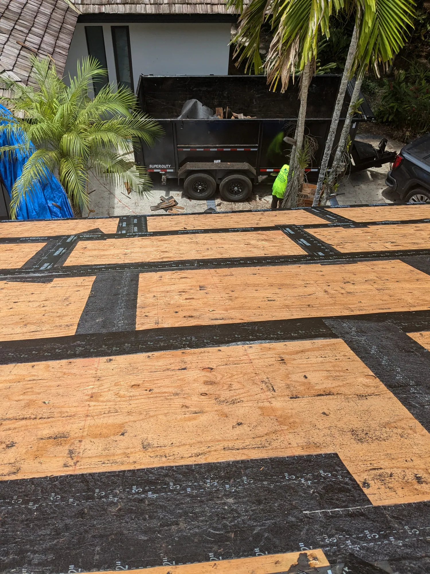 Charcoal flat tile roof installation by DR Construction & Roofing in South Florida