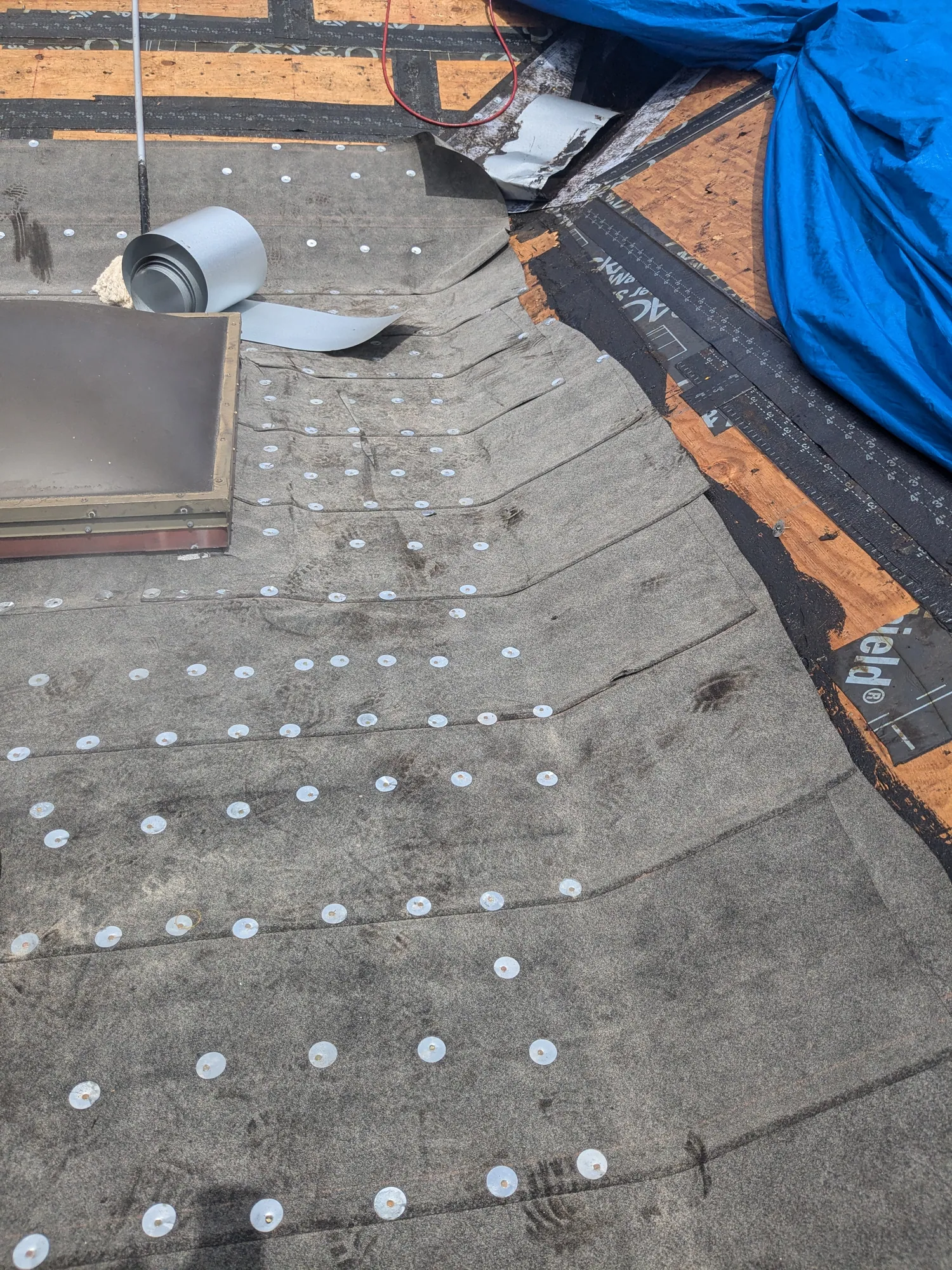 Charcoal flat tile roof installation by DR Construction & Roofing in South Florida
