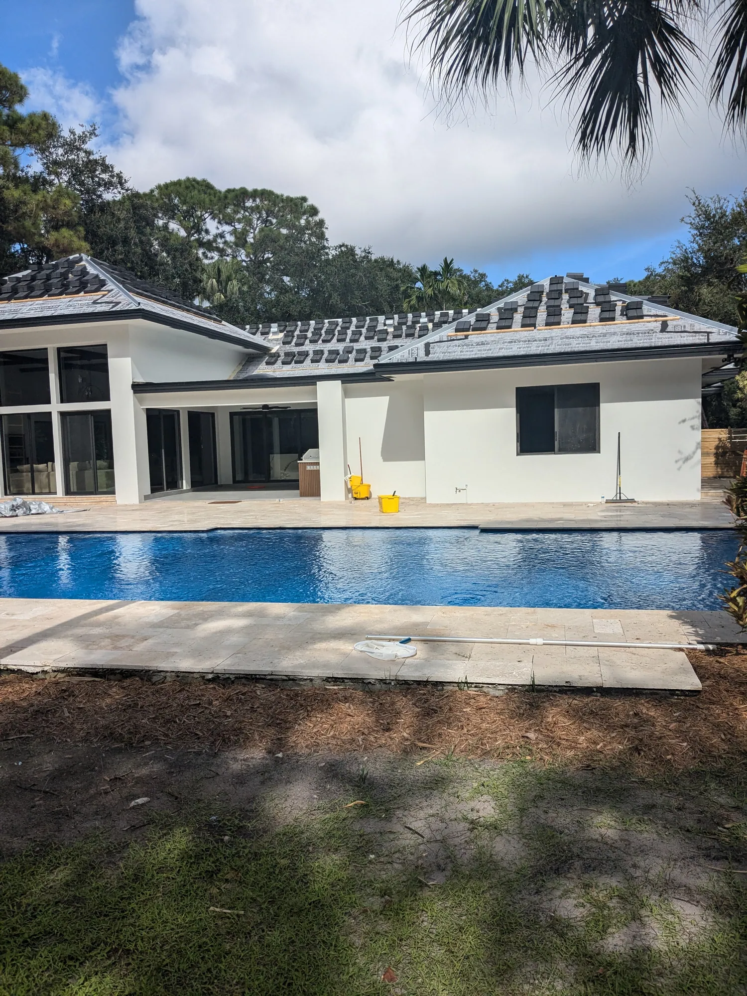 Charcoal flat tile roof installation by DR Construction & Roofing in South Florida
