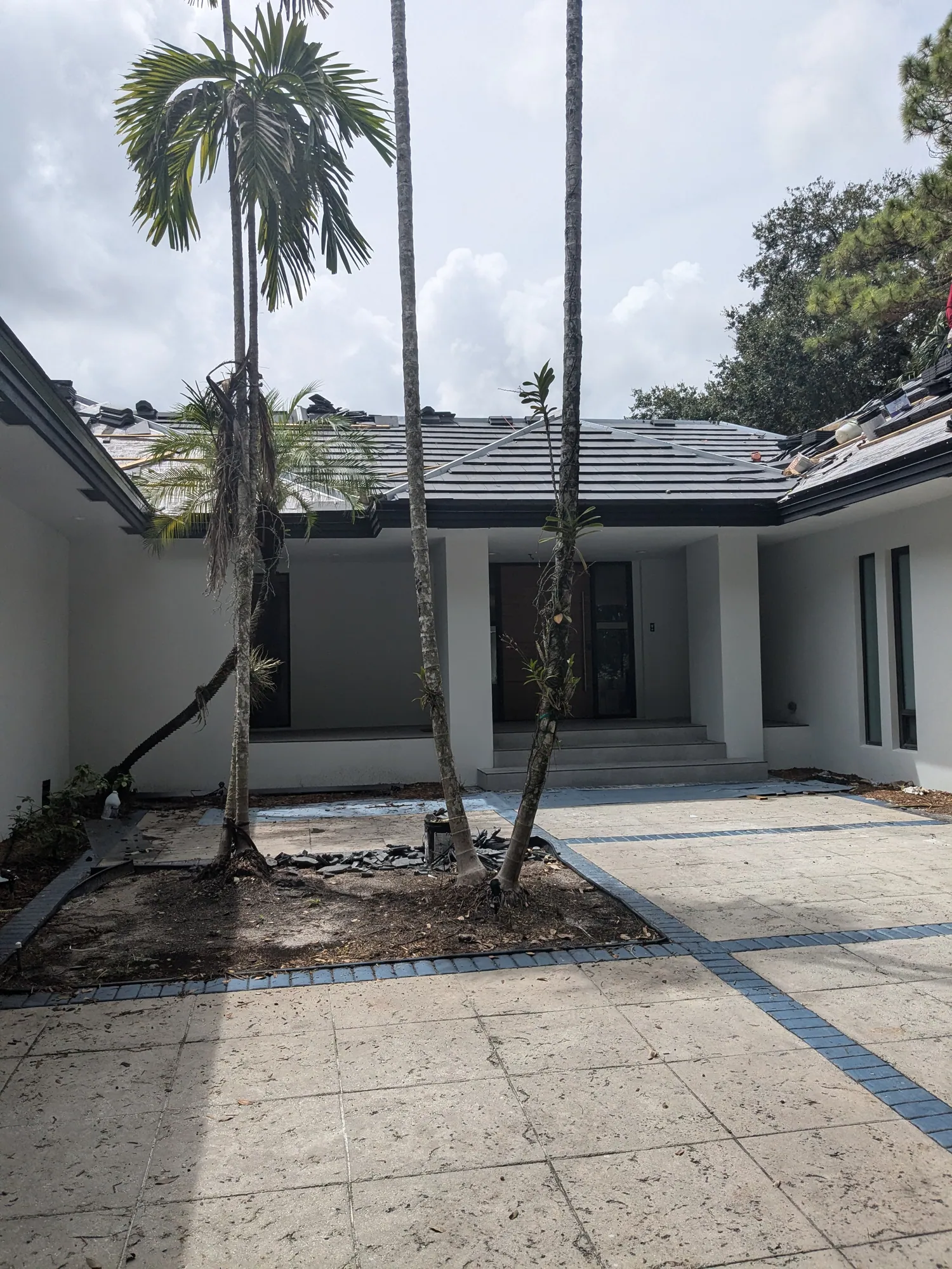 Charcoal flat tile roof installation by DR Construction & Roofing in South Florida