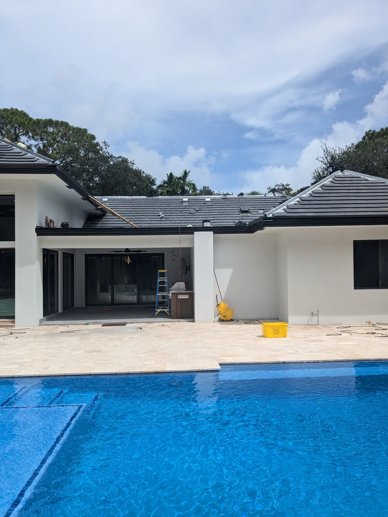 Charcoal flat tile roof installation by DR Construction & Roofing in South Florida