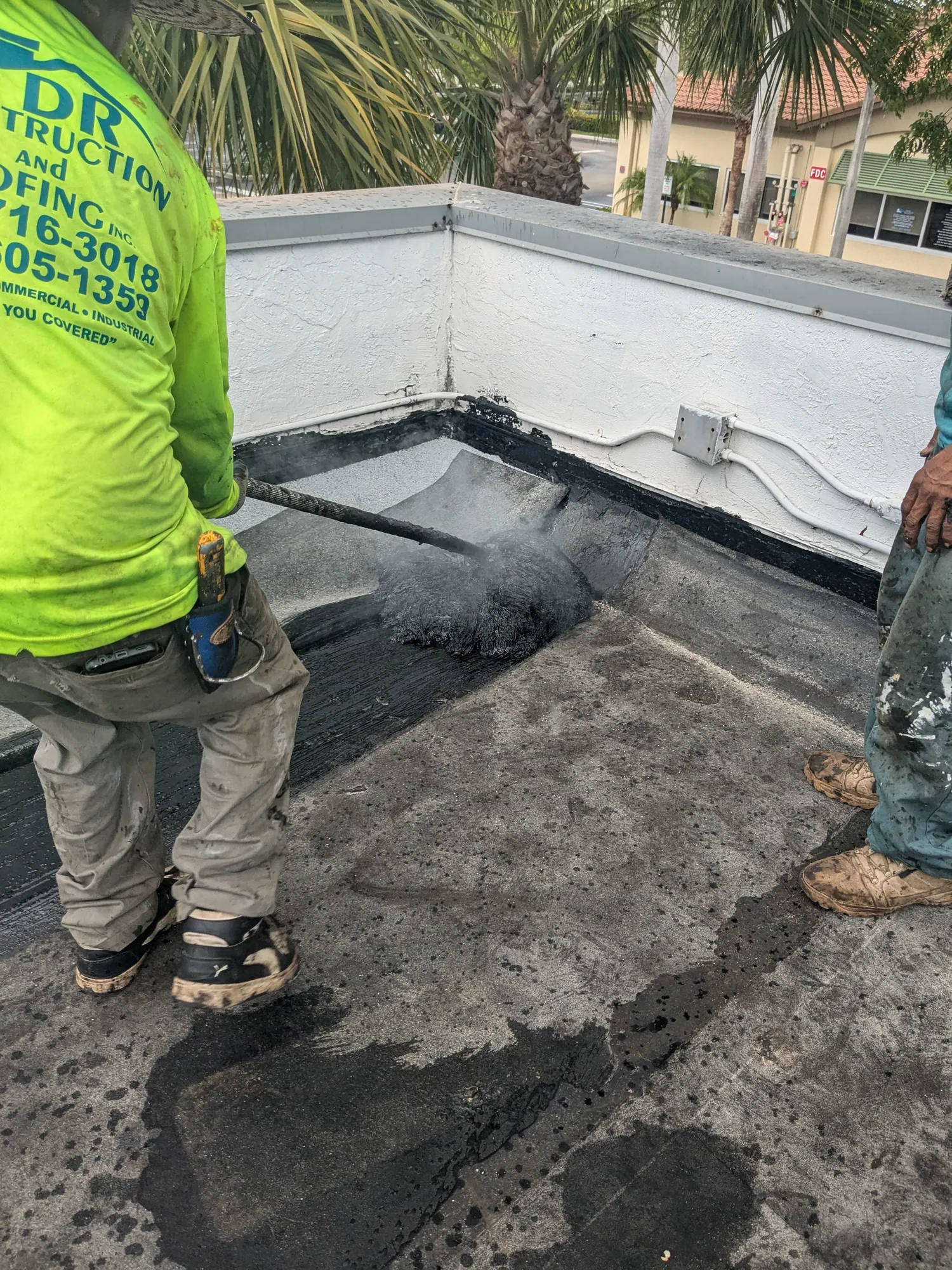 Finished white reflective flat roof coating on a South Florida commercial building