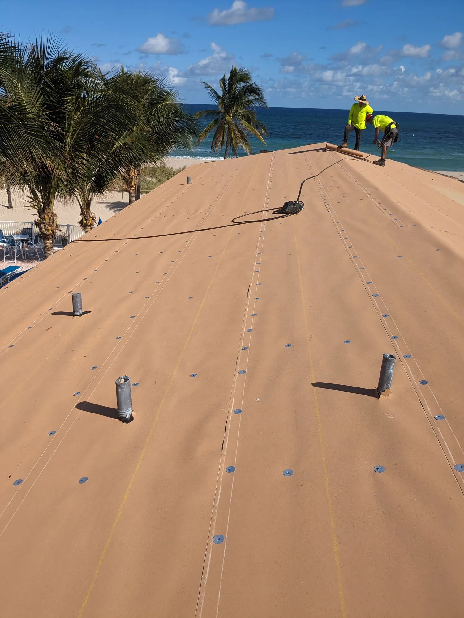 Finished standing seam metal roof on a South Florida oceanfront condo by DR Construction & Roofing